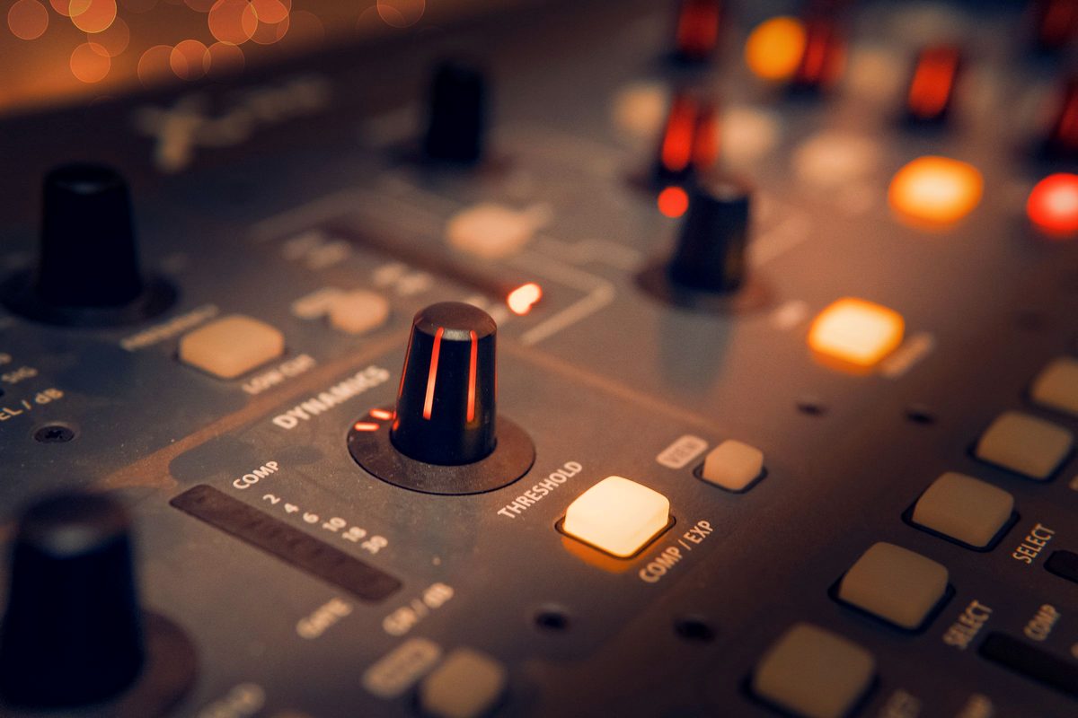 A close-up of a studio mixing console.