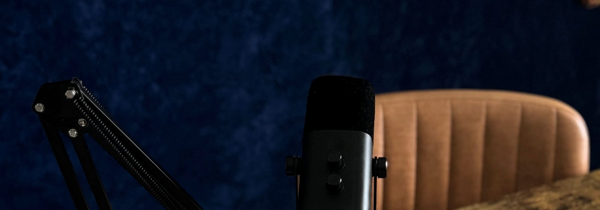 Two podcasters recording in a professional studio.