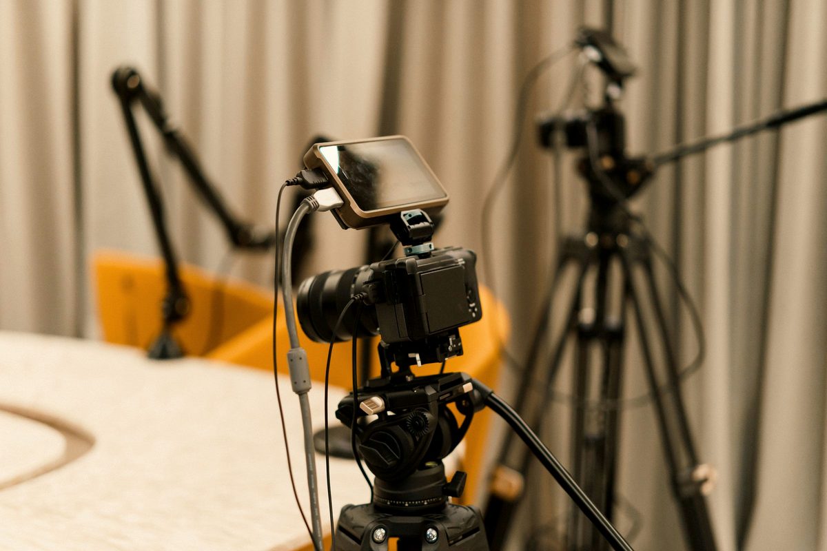 Video cameras and tripods set up in a podcast studio.